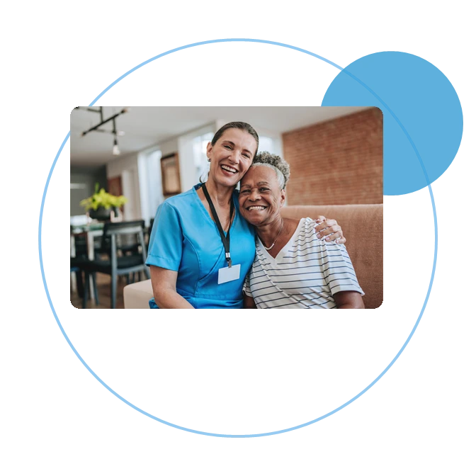 Care professional and an older adult smiling together